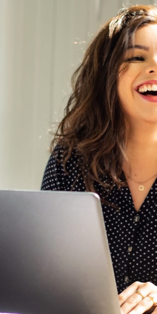 woman smiling laughing laptop